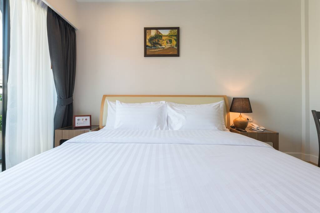 Comfortable king size bed with balcony.