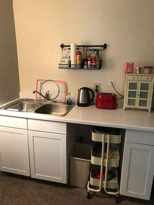 Kitchenette includes a coffee pot, toaster and tea kettle.