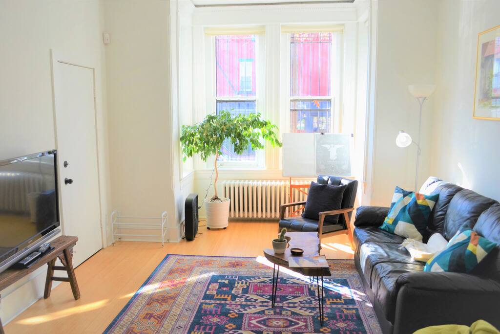 Living room with sun nook towards quiet street, cable TV