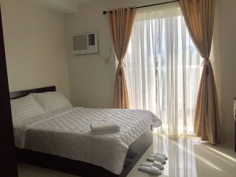 Queen size bed (accommodates 2) with balcony.