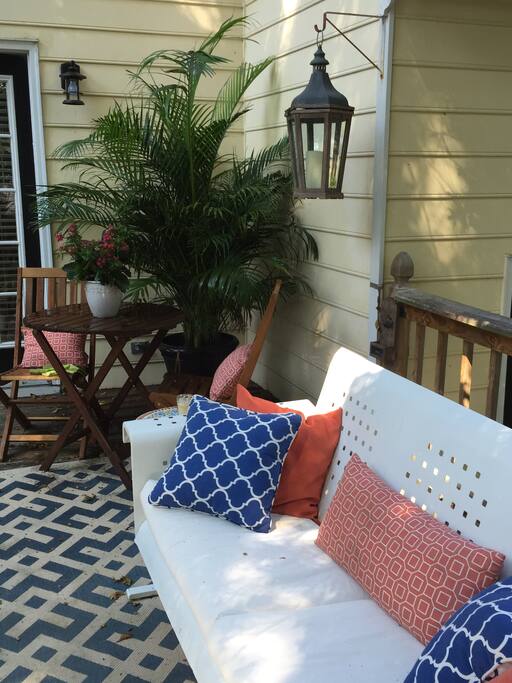 Lovely back deck with plenty of seating & old school glider...