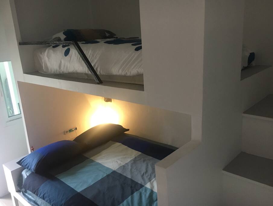 A double bed on the bottom bunk and a single on the top bunk.