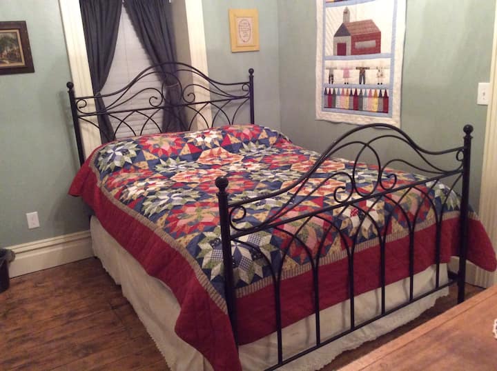 Queen size bed in master bedroom with a large walkin closet.