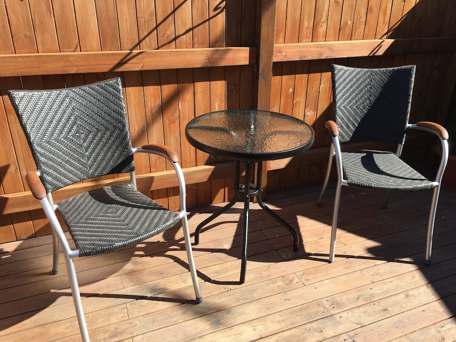 Patio with chairs and a small table.