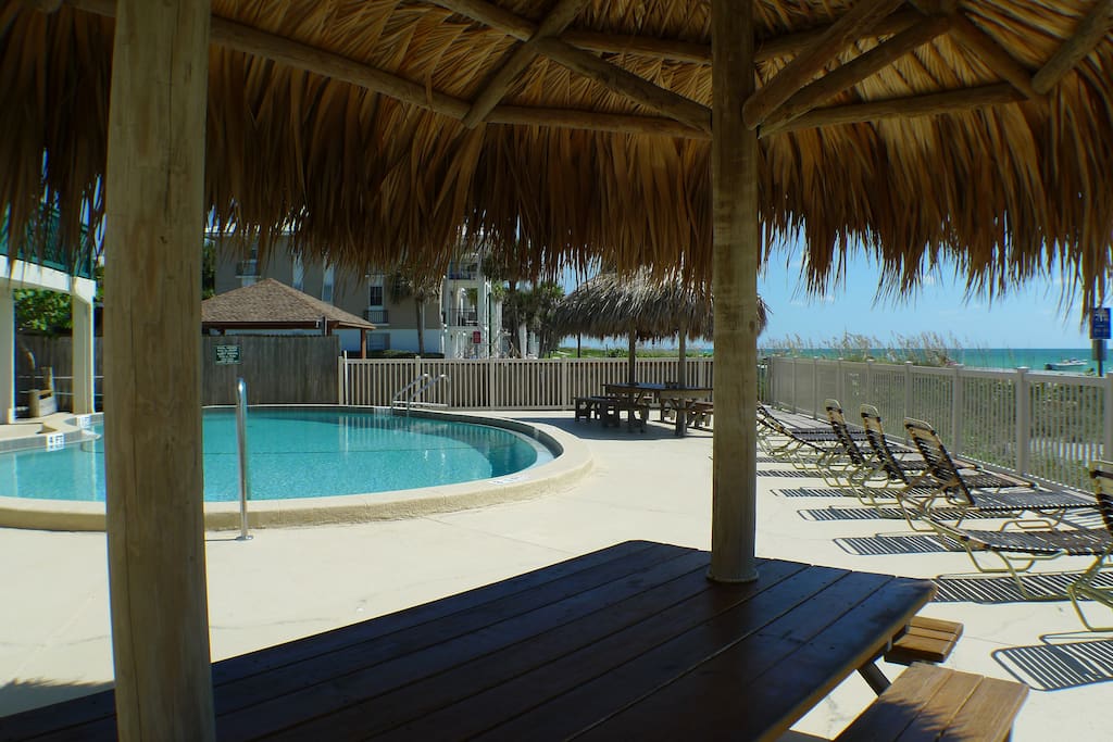 Our tiki huts and pool facing the beach