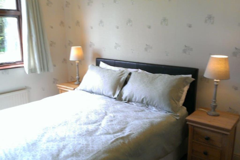 Comfortable king size bed with pillows guests love!