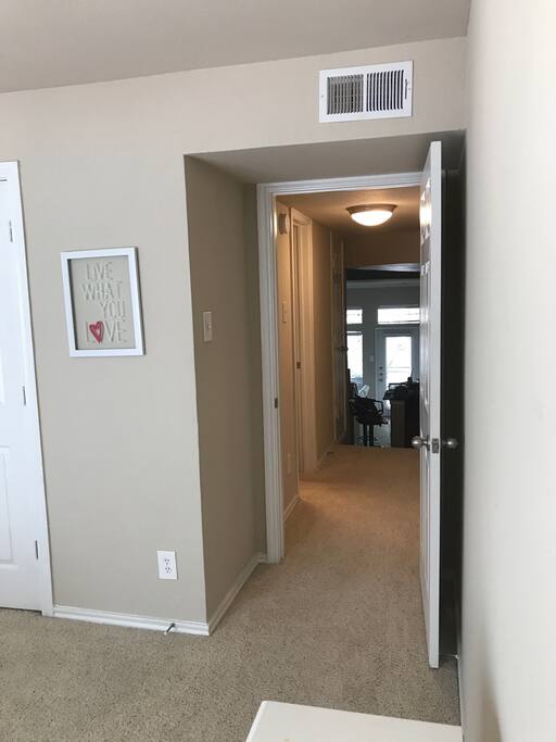 Hallway off bedroom that leads to private full bath with extra towels, soap, toothbrushes, toothpaste, first aid kits and plenty more!