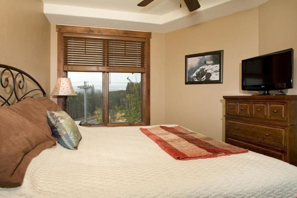 The bedrooms feature large windows with beautiful views