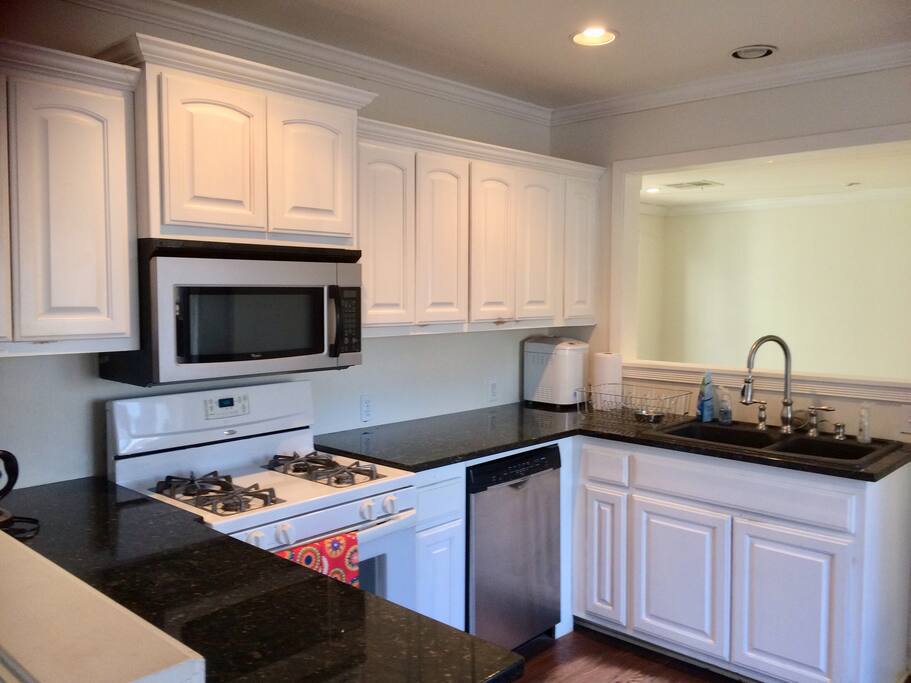 There are two pony walls separating the kitchen in the middle, from the dining room to the west and the living room to the east.