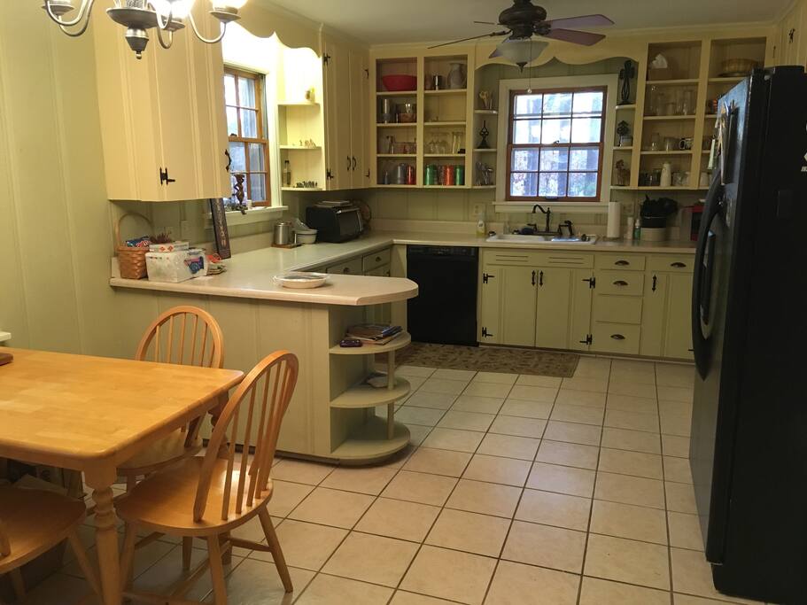 Full kitchen furnished with pans, dishes, and tools