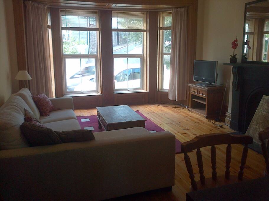 Living Area with a corner sofa and large bay windows