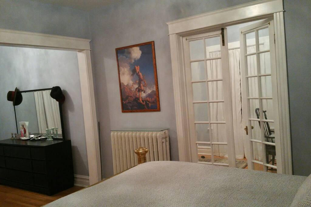 master suite with queen bed,sitting area, sunroom