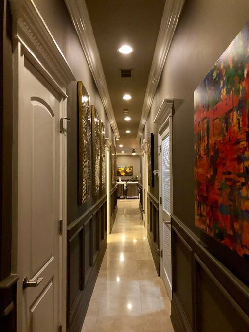 As you enter the unit, you are greeted with a long hallway with lots of glam and drama
