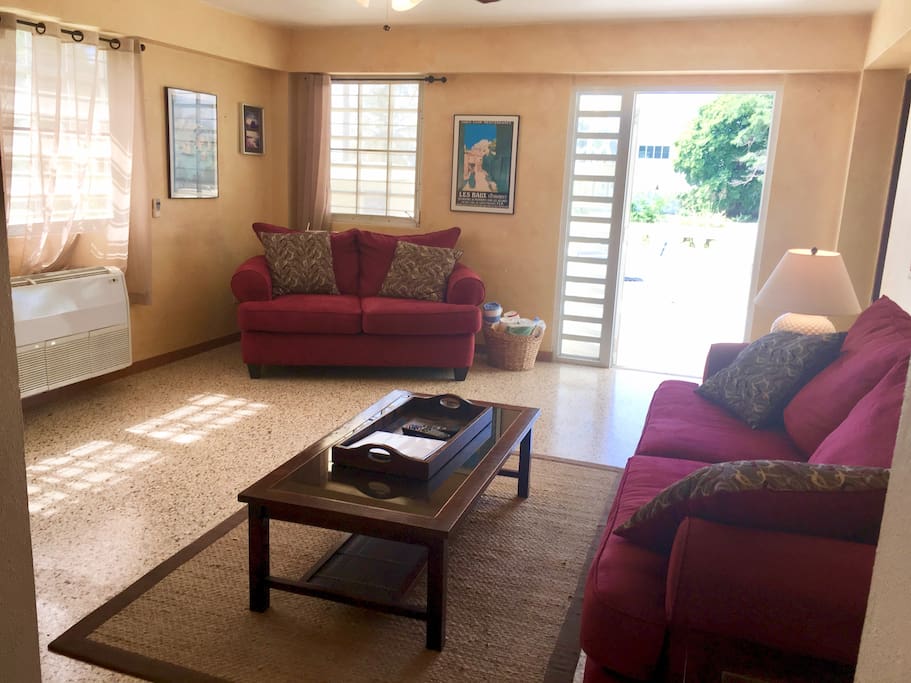 Sunny air-conditioned living room with door out to patio