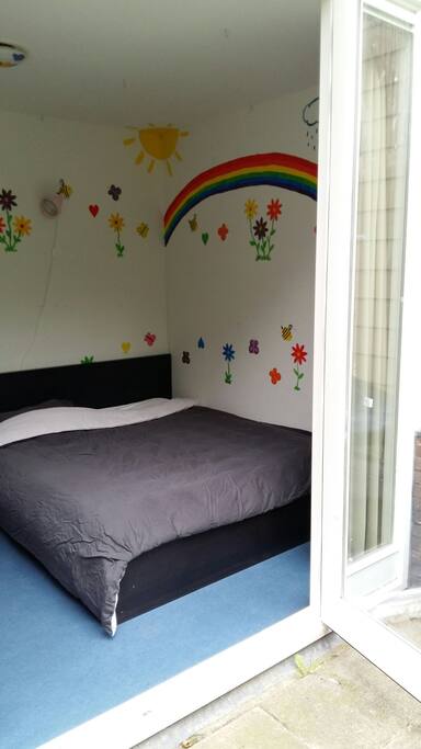 Bedroom 1 with double bed and doors that lead into the garden.