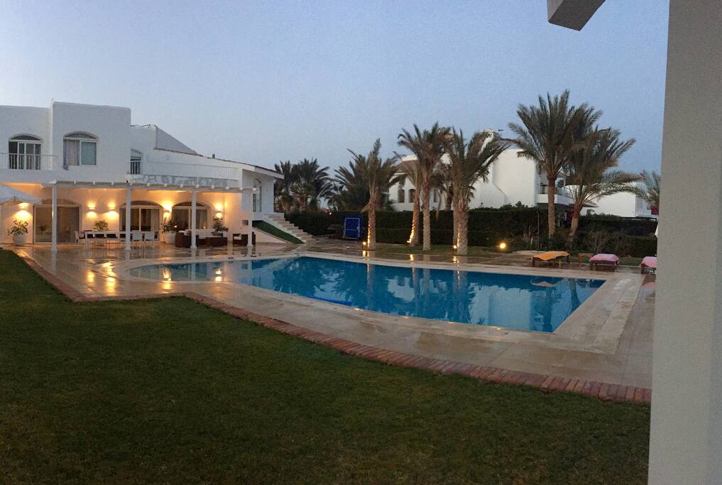 Green garden around the pool, view from seaside