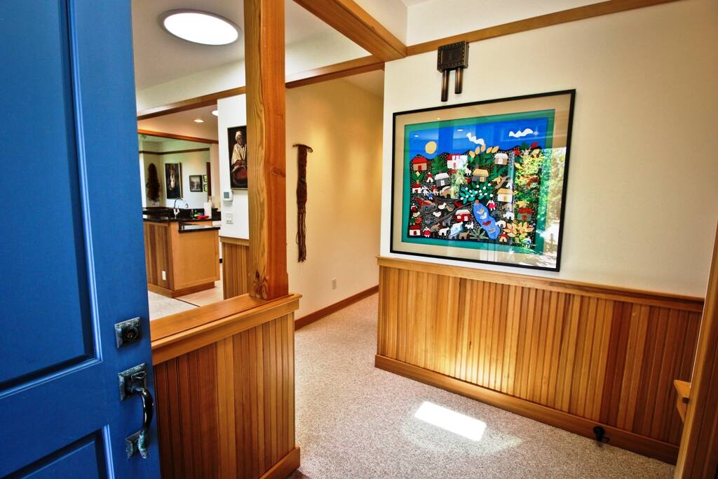 Stone tile entry way with coat closet.