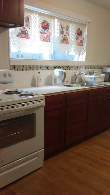 The kitchen on the first floor with refrigerator, stove, and sink.