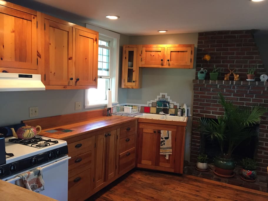 Charming first floor kitchen with amazing natural light and rustic fireplace (inactive but beautiful)