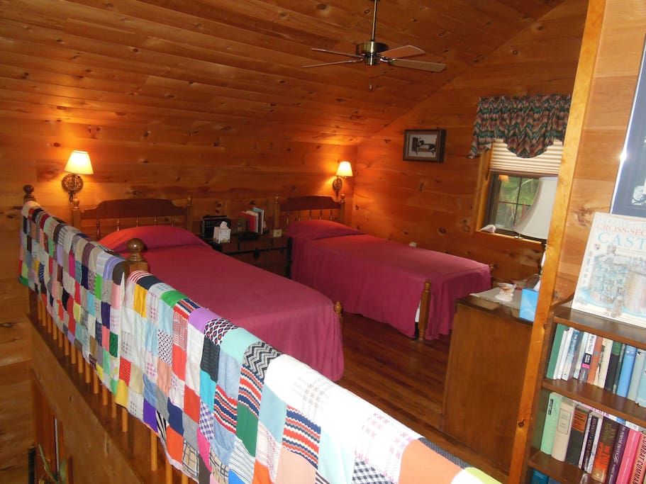 Loft room with 2 single beds and a small closet.