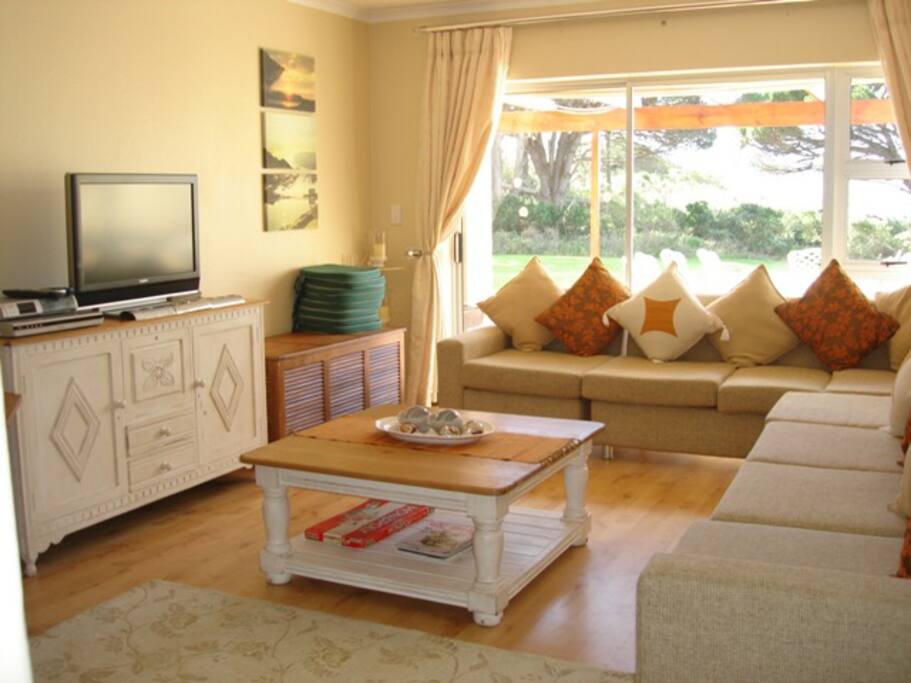 Main lounge with view across patio/terrace