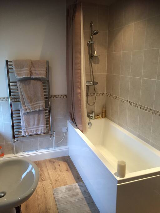 Spacious private bathroom with powerful over bath shower.