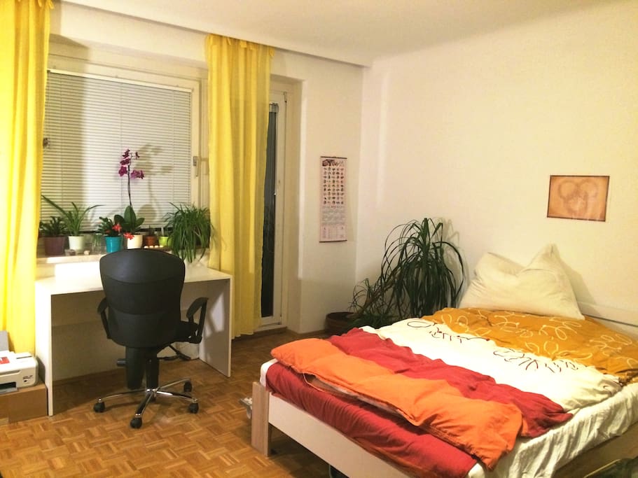 Bed, work spot & greens. Exit to the terrace.