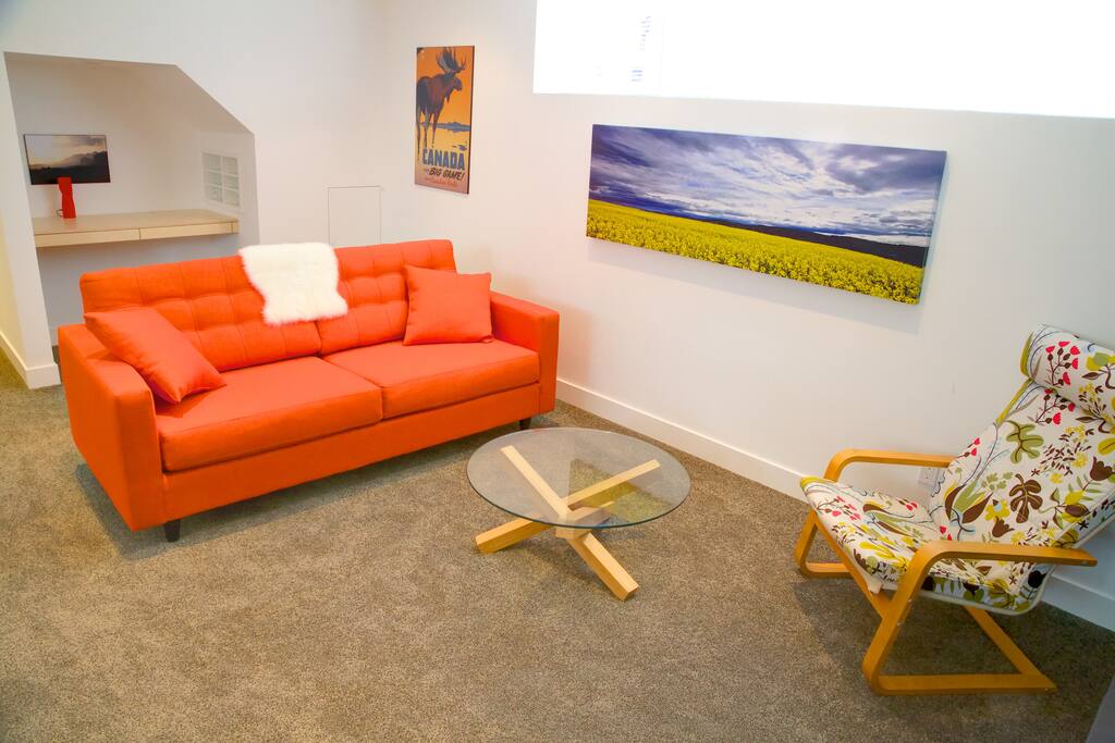 Living area with a built in desk & office chair (behind orange couch). Your own internet (no sharing!:)