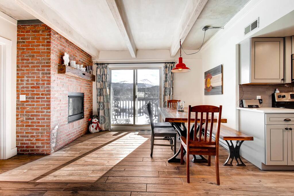 Dining room, fireplace and deck access. Grill and bistro table and chairs.