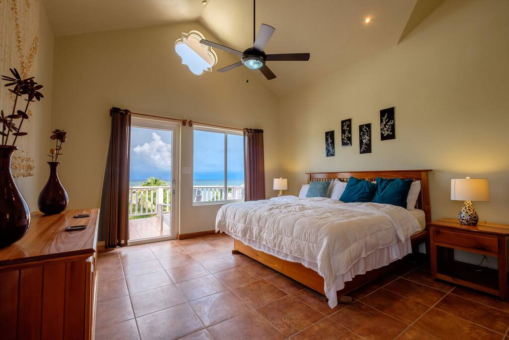 Spacious bedroom with king-sized bed, vaulted ceiling, incredible views.