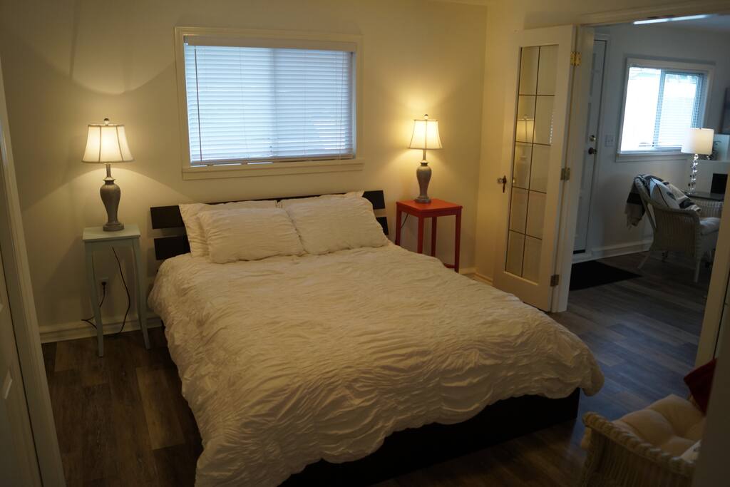 Queen Bed with french door to living room