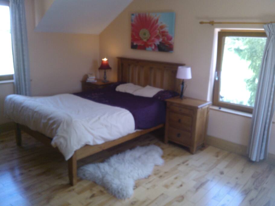 Master bedroom with gorgeous cherry wood flooring