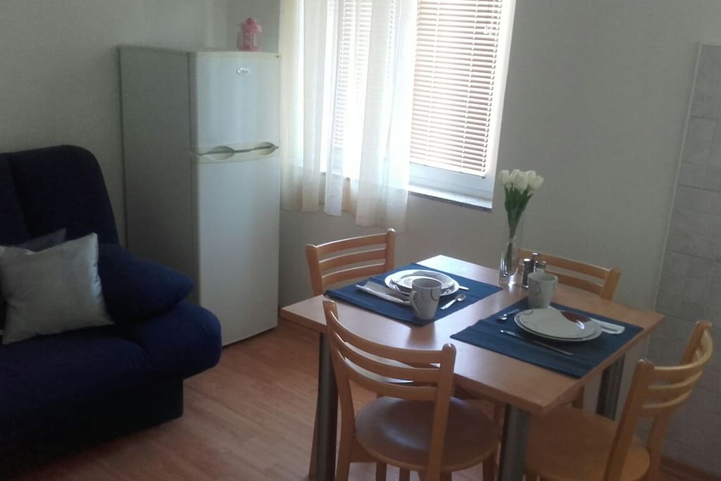 Dining room with sofa bed and kichen