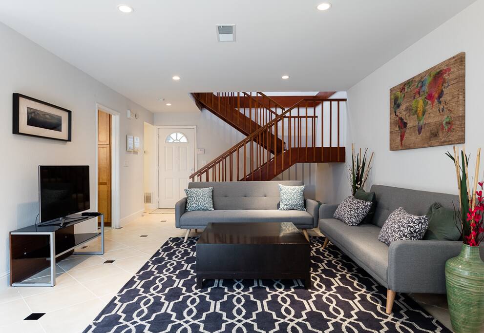 Ground floor living room and stairs leading to 2nd level