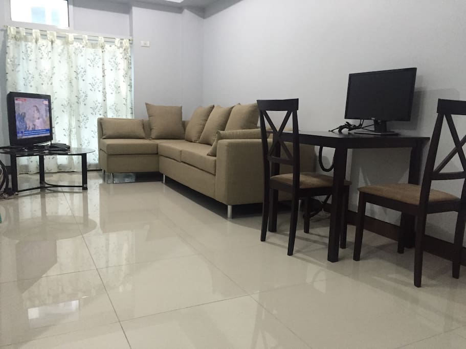 Living room with 4-seater sofa, 32" LCD tv installed with cable tv, and up to 8mbps broadband internet, wifi enabled.
Dining area with dining table for 2.