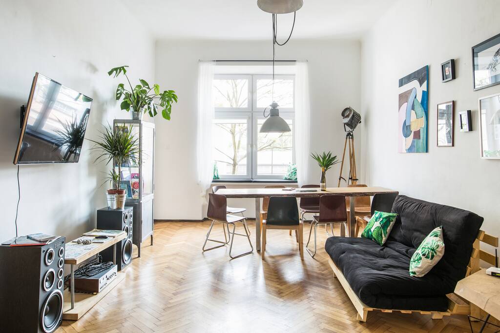 Living room with a sofa bed and a large oak table for 8 people