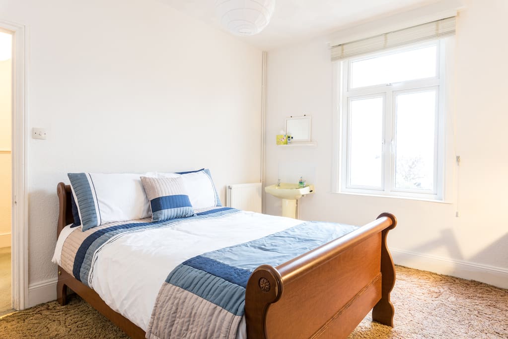 Comfy double bed, convenient washbasin and window on to garden.