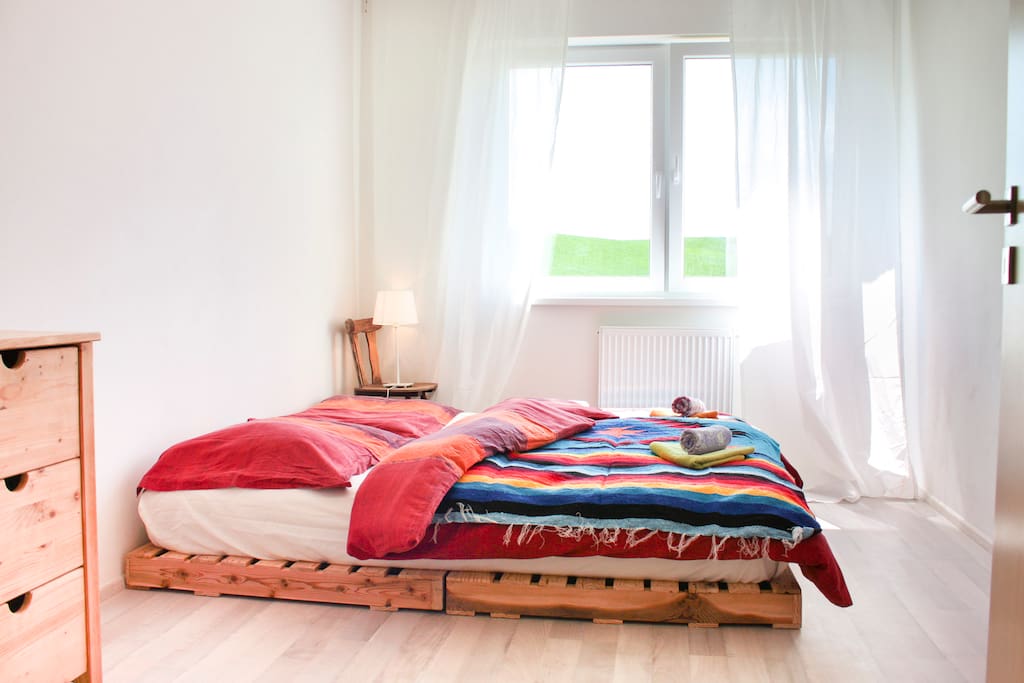 The master bedroom featuring large pallete bed with super comfortable futon to sleep on