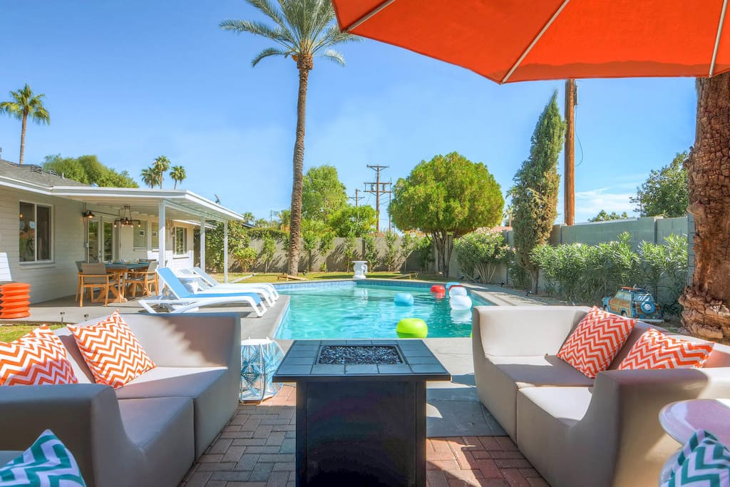 Amazing back yard with large pool, seating area with fire pit, ping pong table and corn holes