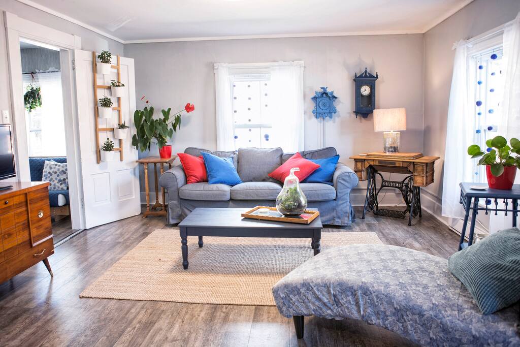 This bright living area has a TV with Netflix, board games .