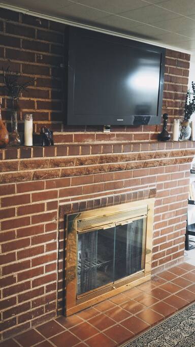TV with entertainment subscriptions and working fireplace.