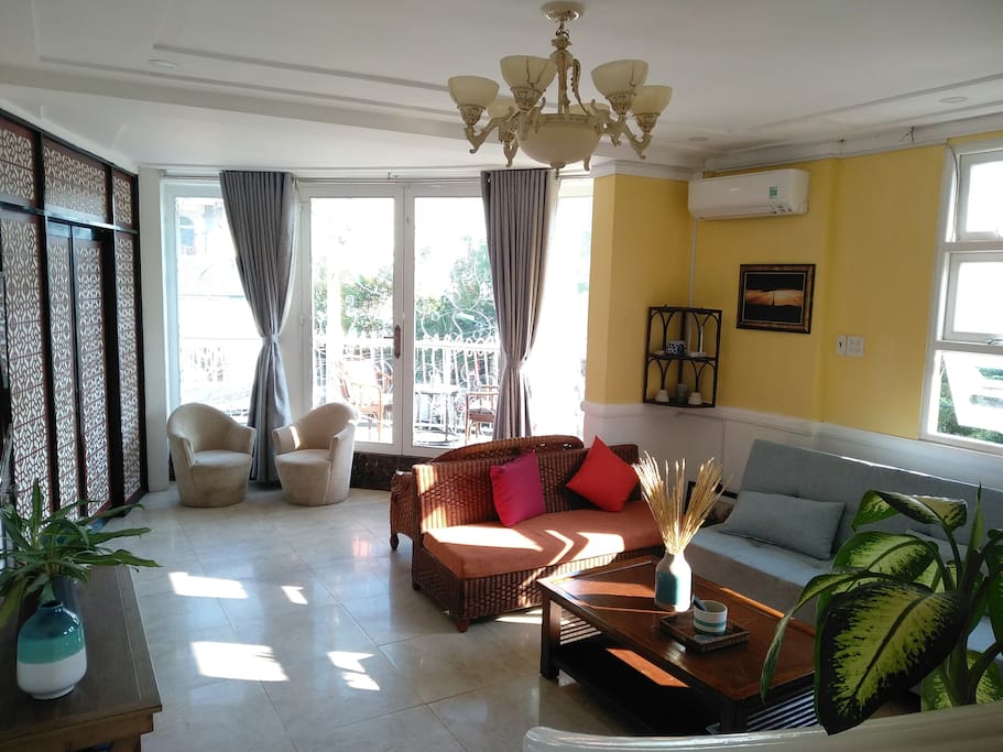 Big bay windows in the living room leading to the balcony.
