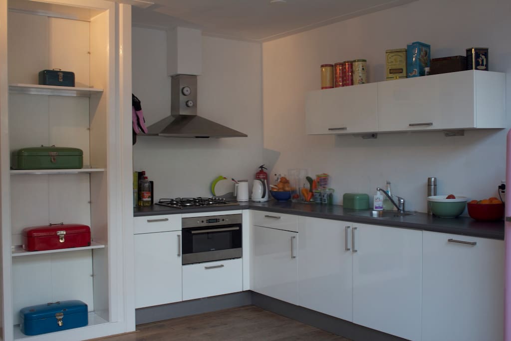 Kitchen with vintage pink fridge and bread bins.