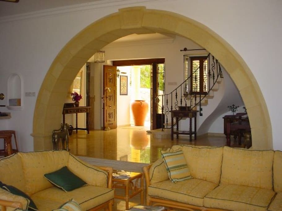 Front door and seeping staircase leading upstairs