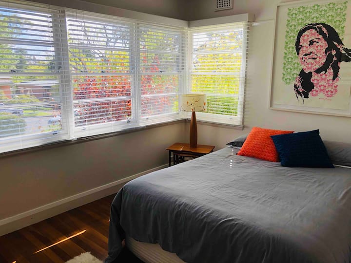 The main bedroom has a queen bed and lots of light