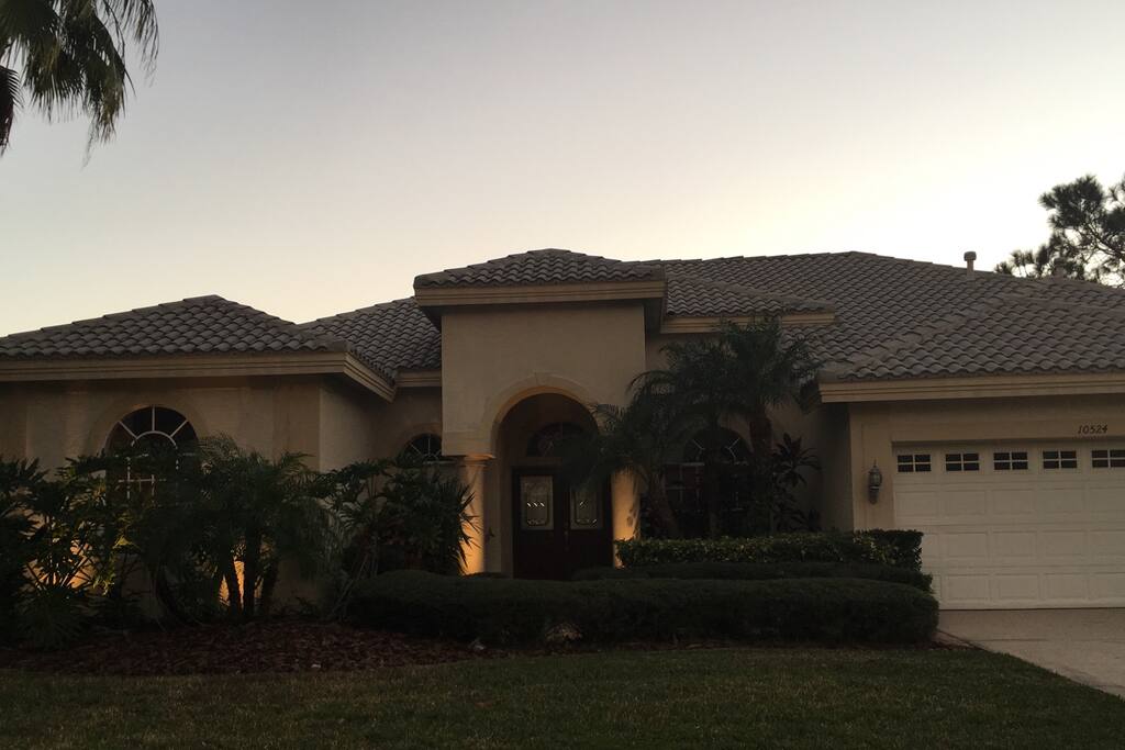 Front view of home with lush landscape