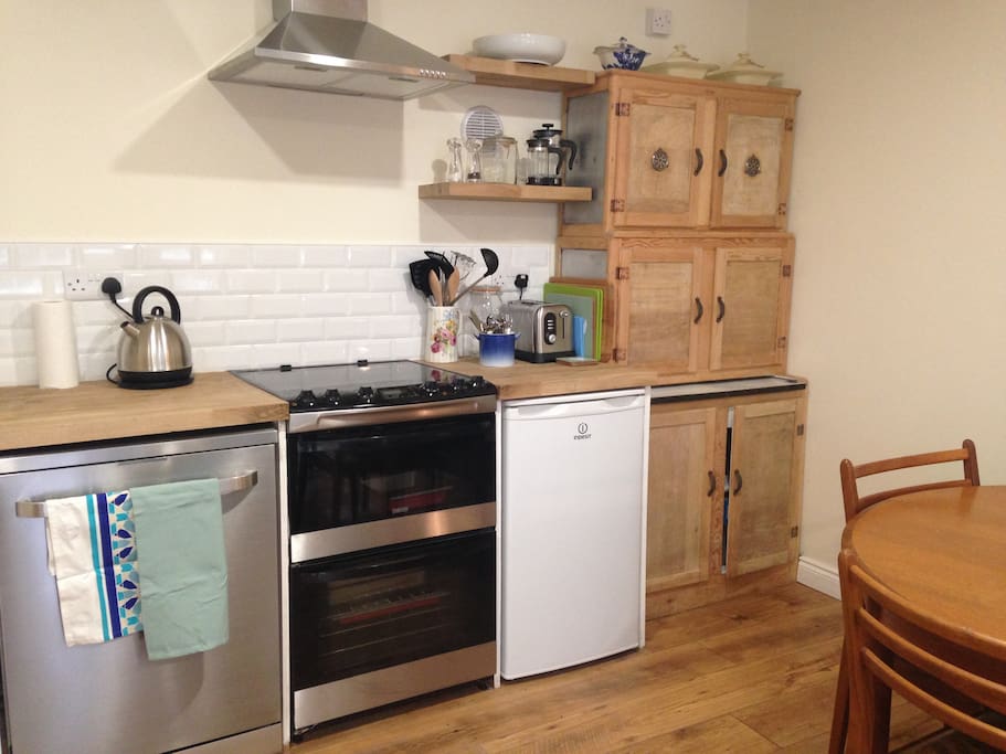 The kitchen is a mixture of vintage furniture and modern appliances