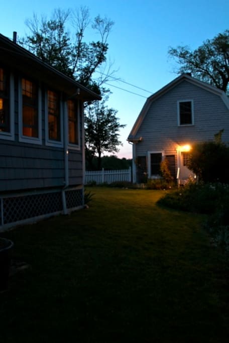 East side of house looking north toward barn at dusk