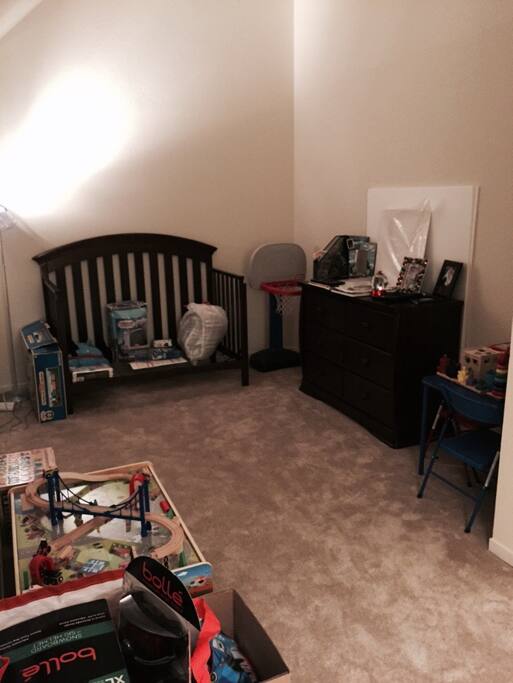 A daybed, great for toddlers. There is a train set upstairs they can play with, a sitting table with a bunch of other toys and puzzles and books that they can read.