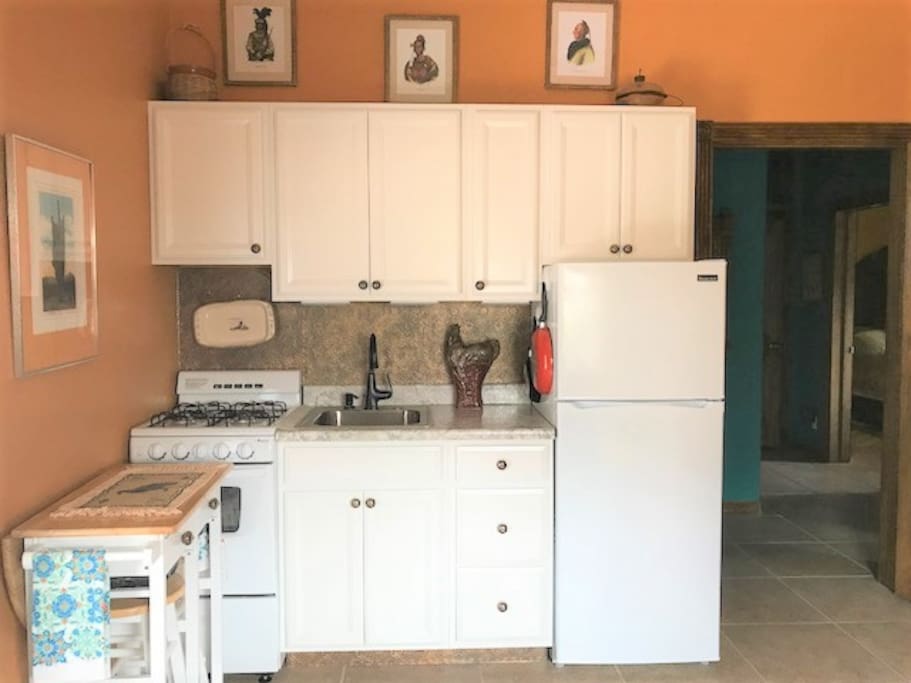 Kitchen area is complete with coffee, tea, and some food to make breakfast with.